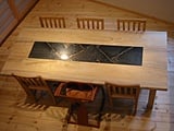 楠の無垢材で作った大テーブルの中央に鉄板を埋め込みました。表面には象眼細工を施しています。一点物です！！！！